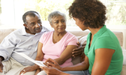 caregiver introducing benefits to old couople