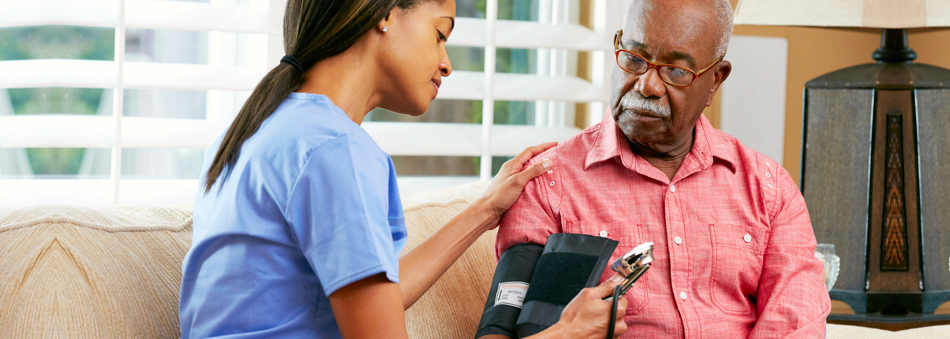 caregiver taking blood pressure