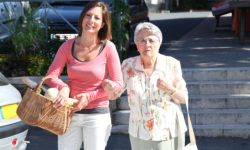 caregiver and old woman walking